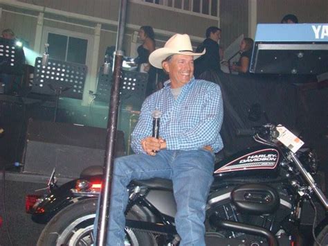 George Sitting On A Harley That Is Getting Ready To Be Auctioned For