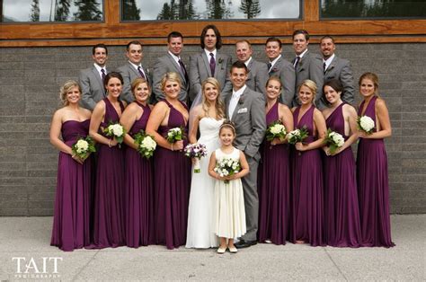 A Group Of People Standing Next To Each Other In Front Of A Building