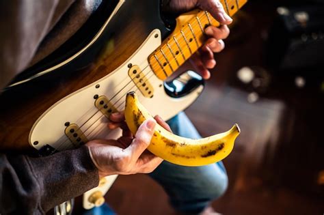 Premium Photo Midsection Of Man Holding Guitar