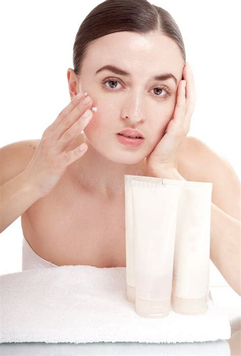 Sensual Woman Applying Cosmetic Cream Treatment On Her Face Stock