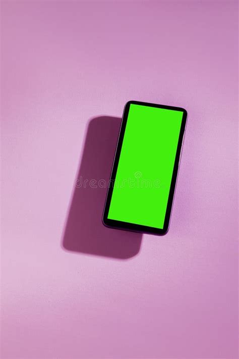 Smartphone With Green Screen On Top Of A Pink Table Stock Image