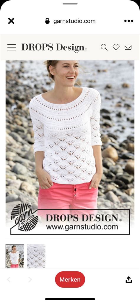 A Woman Standing Next To A White Crocheted Tablecloth On The Beach With