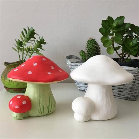 Three Small Mushrooms Sitting Next To Each Other In Front Of A Potted