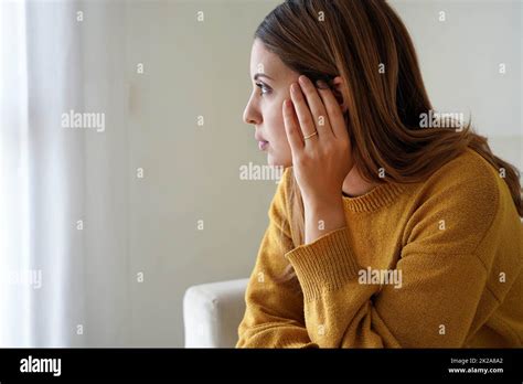 Portrait Of Sad Lonely Girl At Home Looking Through Window Mental