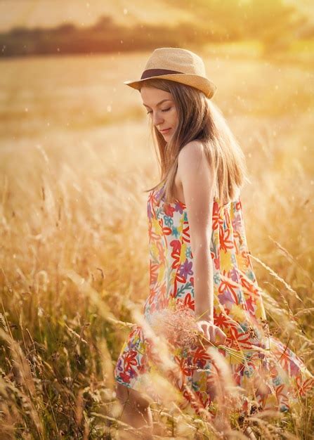 Premium Photo Woman In Dress And Hat Walking In A Wheat Field In Summer