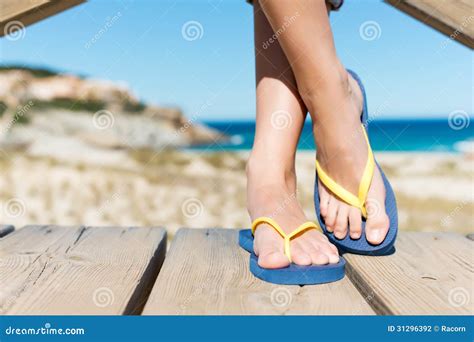 Woman Wearing Flip Flops While Standing On Board Walk Stock Photography