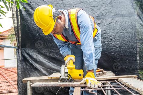 Carpenter Using Circular Saw For Cutting Wooden Boards With Power Tools