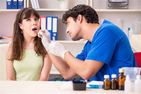 The Doctor Getting Saliva Test Sample In Clinic Hospital Stock Photo