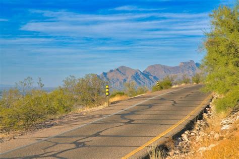 Cliffside Road With Yellow And Black Warning Posts And A View Of