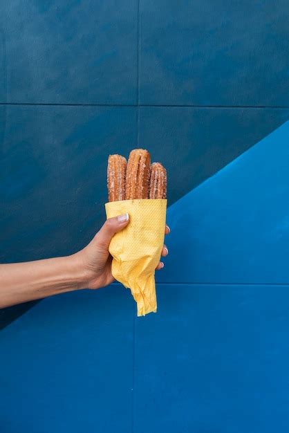 Free Photo Close Up Person Holding Up Food With Blue Background