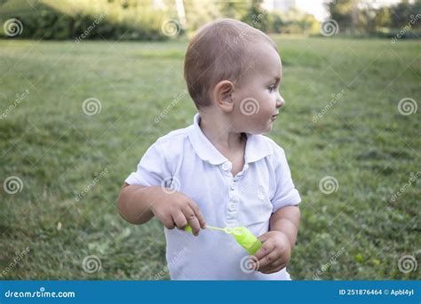 Little Boy Inflates And Bursts Soap Bubbles Cute Funny Kid Is Playing