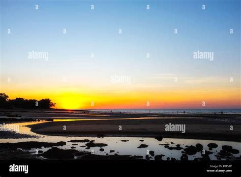 Nightcliff Beach At Sunset With People Silhouettes In A Suburb Of