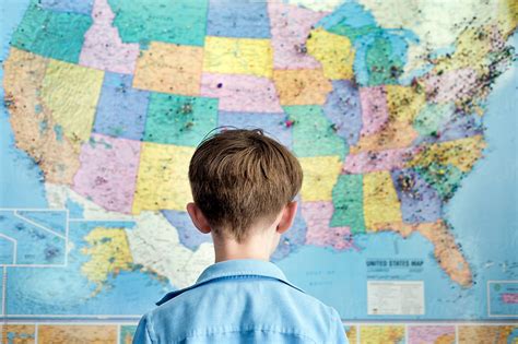 "Boy Looking At A Map Of The United States" by Stocksy Contributor "Cara Dolan" - Stocksy