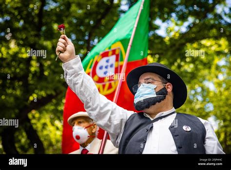 A Man Dressed As Z Povinho Seen With A Red Carnation In His Hand