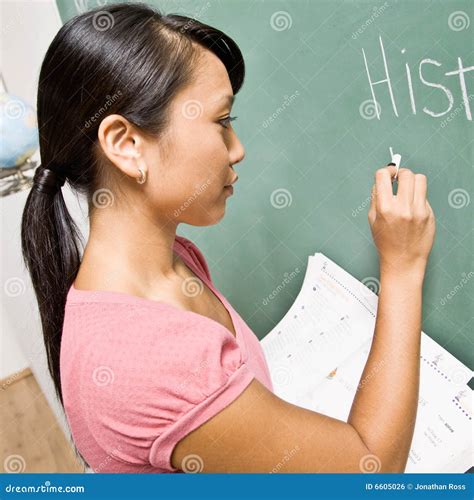 Teacher Writing On Blackboard Schoolteacher Explaining Lesson In