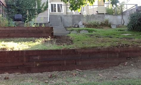How to build a retaining wall with railroad ties - Builders Villa