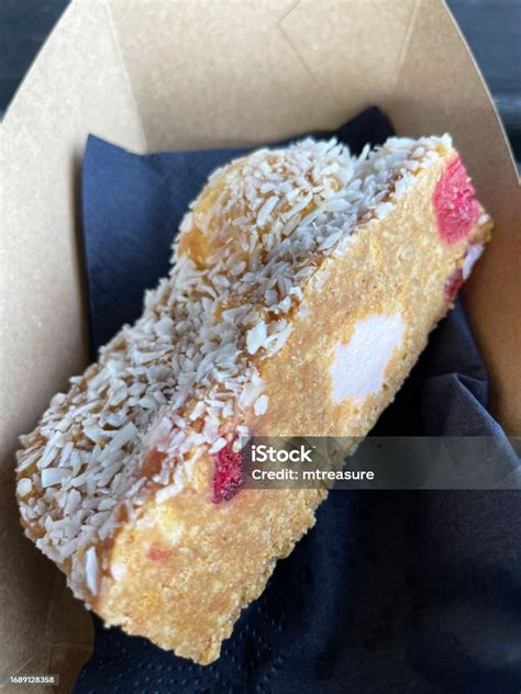 Closeup Image Of Irish Fifteens Unbaked Fridge Cake Slice In Cardboard Disposable Container