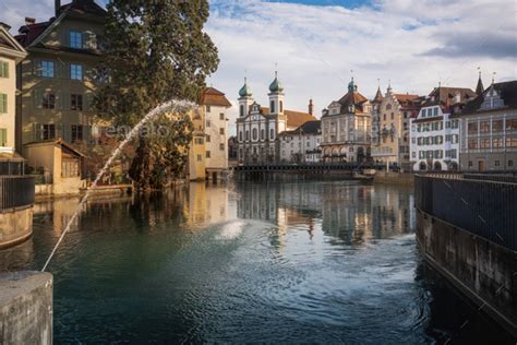 Reuss River Fountain And Luzern Skyline With Jesuit Church Lucerne