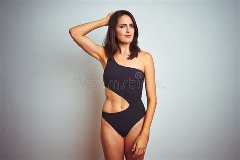 Beautiful Woman Wearing Bikini Swimwear Over White Isolated Background Confuse And Wonder About