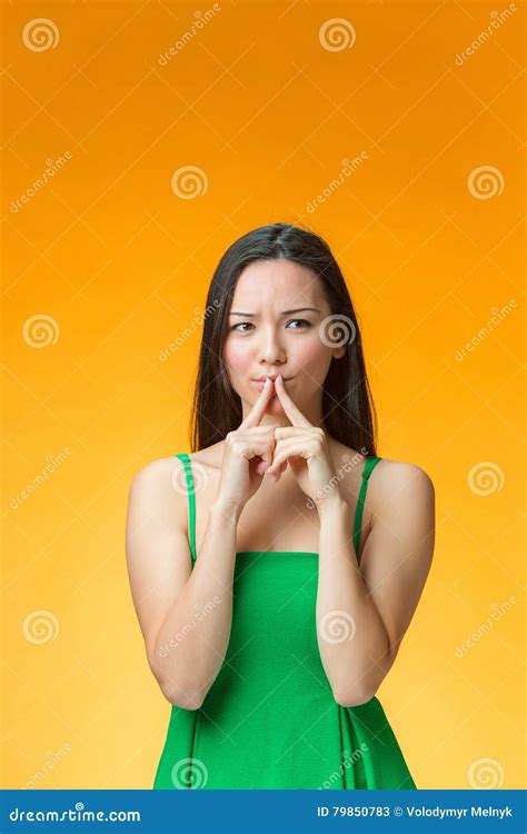 The Thinking Chinese Girl On Yellow Background Royalty Free Stock
