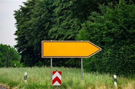 Premium Photo Blank Directional Road Signs Against Park