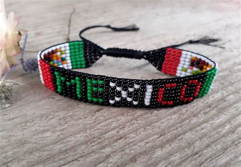 A Beaded Bracelet With The Word Mexico On It Next To A Small Flower