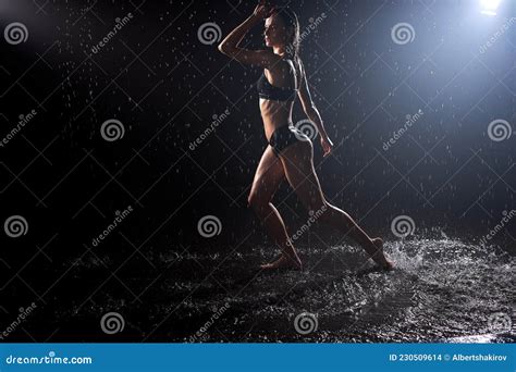 Attractive Caucasian Woman In Candid Lingerie Posing Under Rain Water