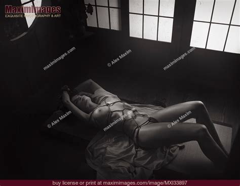 Beautiful Nude Woman Lying On The Floor Tied Up With Red Shibari