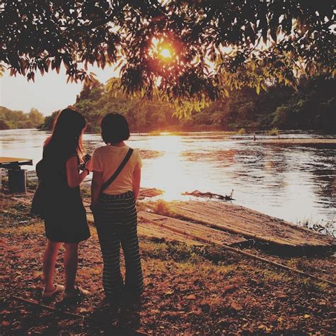 Premium Photo Rear View Of Women Standing At Lakeshore