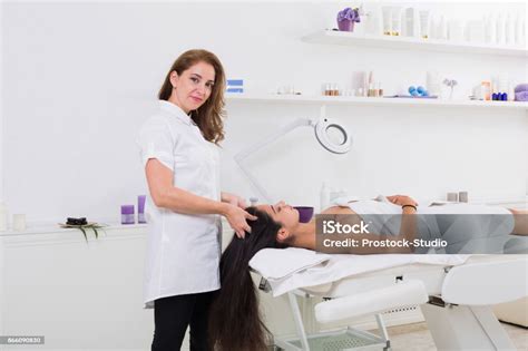 Woman Beautician Doctor Make Head Massage In Spa Wellness Center Stock