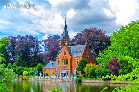 Kasteel Minnewater Lake Of Love Castle Building In Park With Green