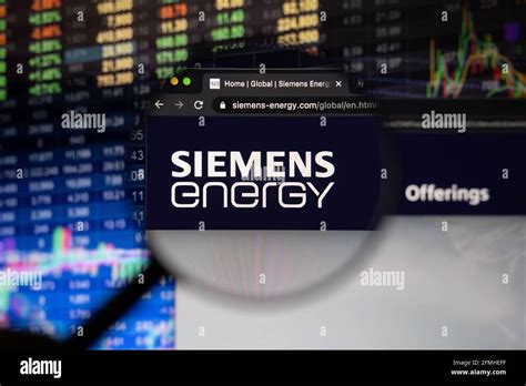 Siemens Energy Company Logo On A Website With Blurry Stock Market