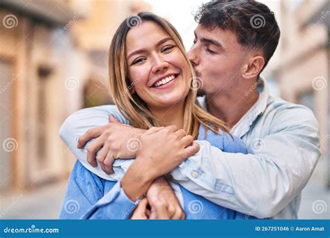 Young Man And Woman Couple Hugging Each Other And Kissing Standing At