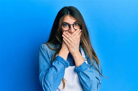 Young Caucasian Woman Wearing Apron Shocked Covering Mouth With Hands For Mistake Stock Image