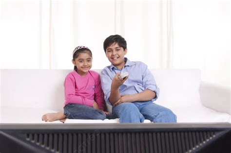 الأخ والأخت يشاهدان التلفزيون صورة الخلفية والصورة للتنزيل المجاني 