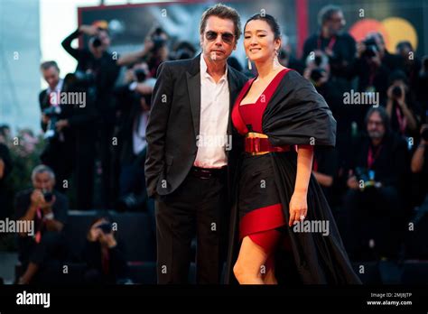 Gong Li and Jean Michel Jarre poses for photographers upon arrival at ...
