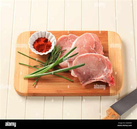 Raw Pork Chops On A Cutting Board Stock Photo Alamy