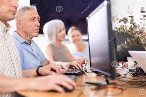 Computer Lessons For Elderly People In Nursing Home Group Of Seniors