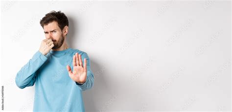 Image Of Caucasian Man Stretch Out Hands To Stop Or Reject Something