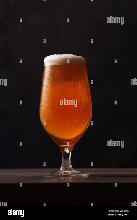 Tulip Glass Of Beer On Black Background Alcoholic Beverage Over Pub