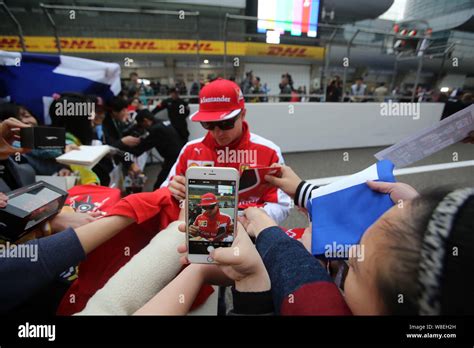 Finnish F Driver Kimi Raikkonen Of Ferrari Signs Autographs For Fans