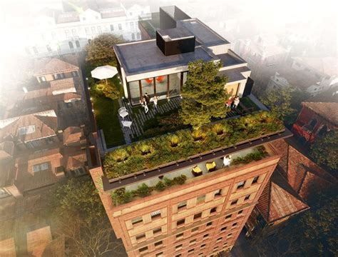 An Aerial View Of The Roof Of A Building With Green Vegetation Growing