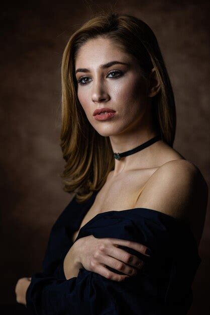 Premium Photo Portrait Of Woman Standing Against Black Background