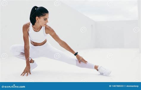 Woman In White Fitness Clothes Doing Warm Up Exercises Stock Image