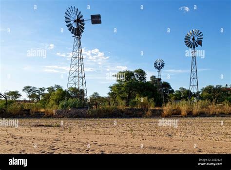 Windmills Of A Farm At The Banks Of The Dry Omaruru River Dry River