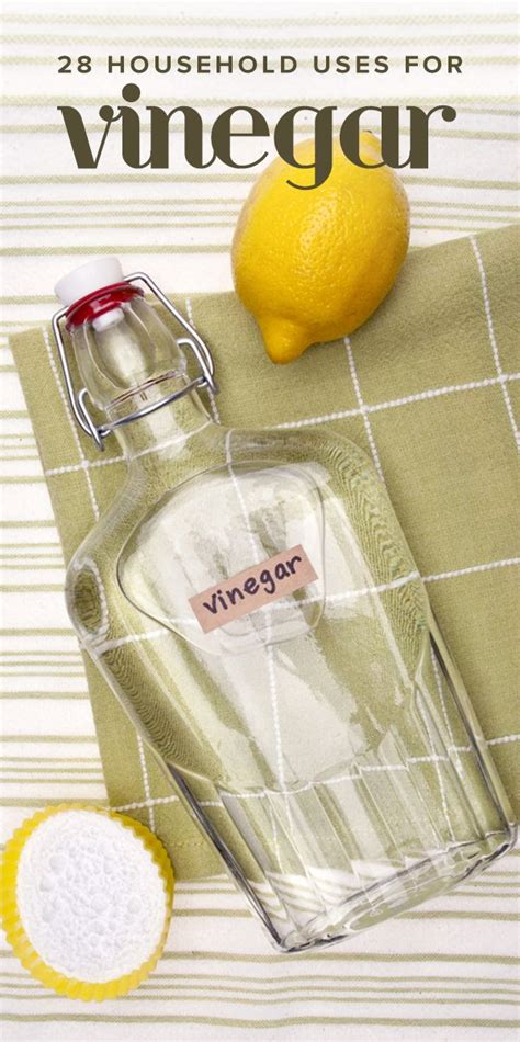 A Bottle Of Vinegar Next To A Lemon On A Towel With The Title