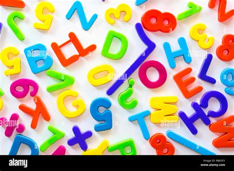 Letters And Numbers Of Different Colors On White Surface Stock Photo