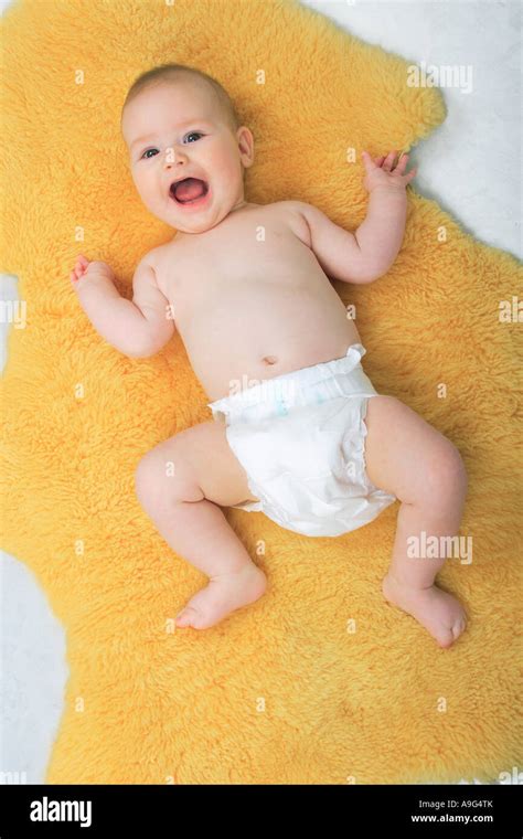 Baby Lying On A Sheepskin Rug Yelling Stock Photo Alamy