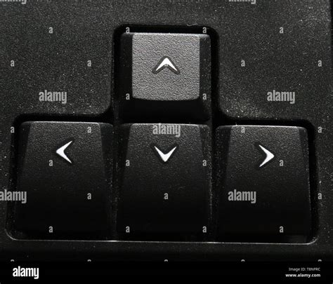 This is a close up photograph of arrow keys on keyboard, showing left, right, up, down keys ...