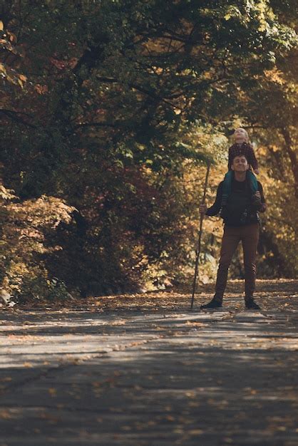 Premium Photo Father With Son On His Shoulders Walking In The Autumn